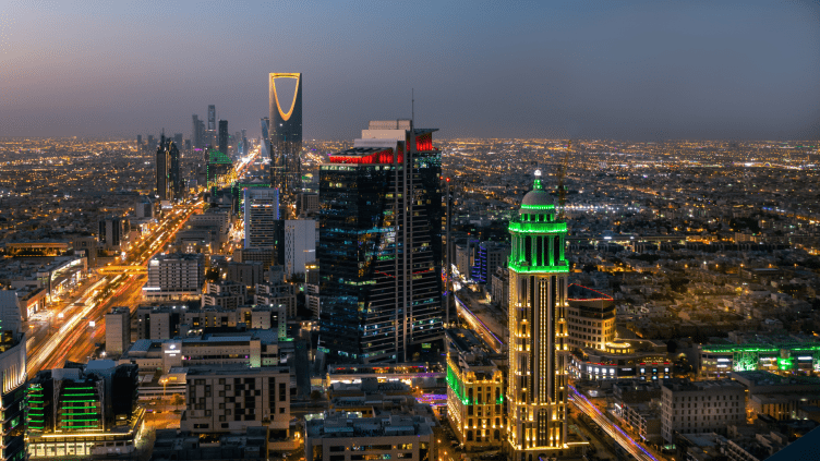 Night view of Riyadh cityscape with skyscrapers.